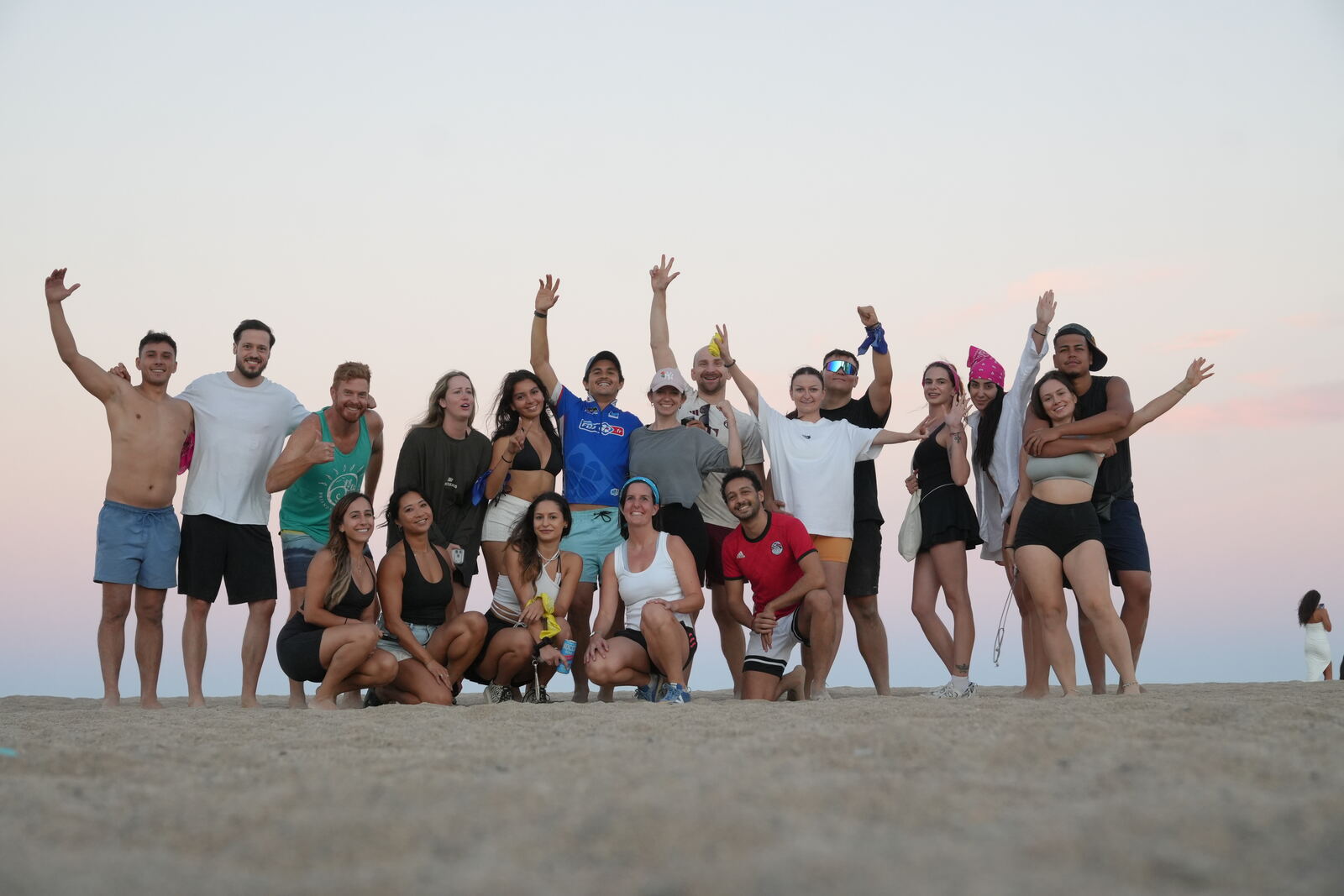 Barcelona Games attendees cheering together on the sand at sunset, Platja del Fòrum, Edition 03.